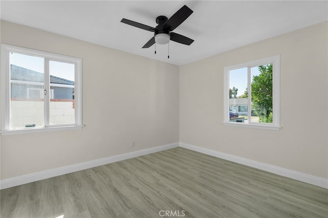 unfurnished room featuring light wood-type flooring, ceiling fan, and a healthy amount of sunlight