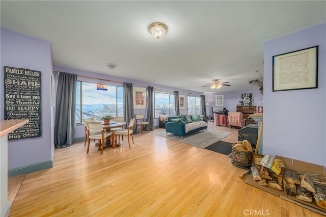 living room with hardwood / wood-style flooring and ceiling fan