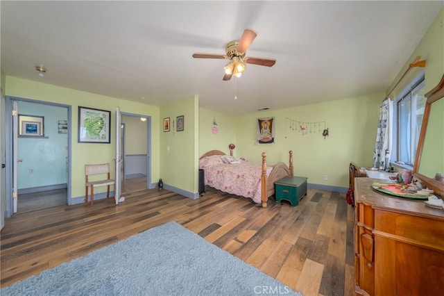 bedroom featuring dark hardwood / wood-style flooring and ceiling fan