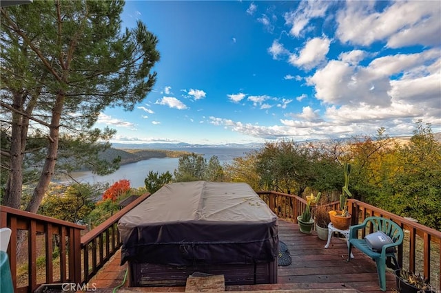 wooden deck with a water view and area for grilling