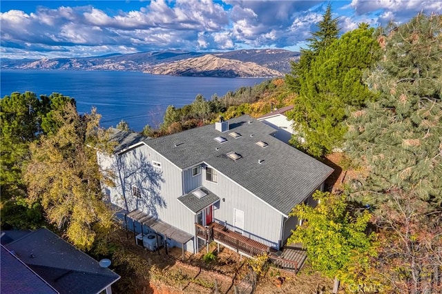 birds eye view of property with a water and mountain view