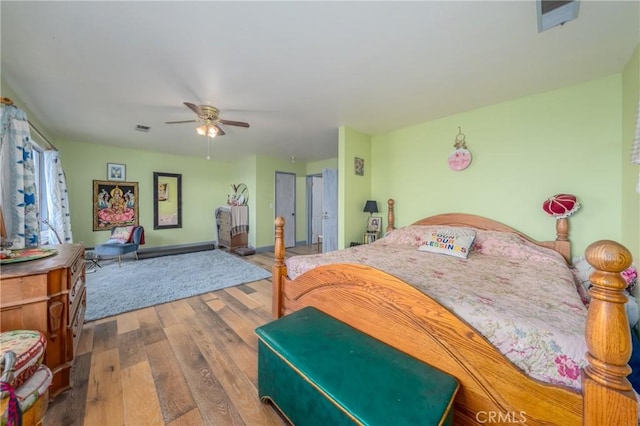 bedroom with ceiling fan and wood-type flooring