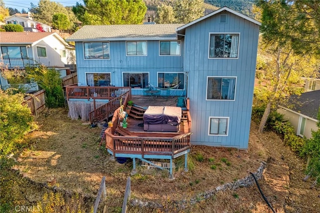 back of house with a wooden deck