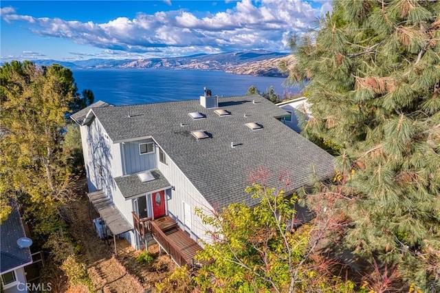 drone / aerial view featuring a water and mountain view