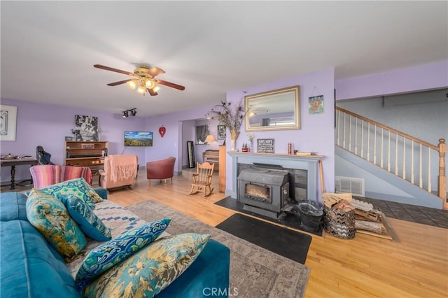 living room with hardwood / wood-style floors and ceiling fan