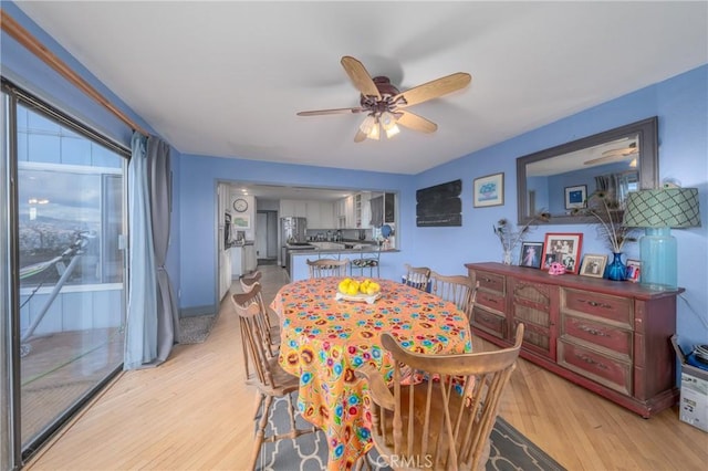 dining area featuring ceiling fan and light hardwood / wood-style floors