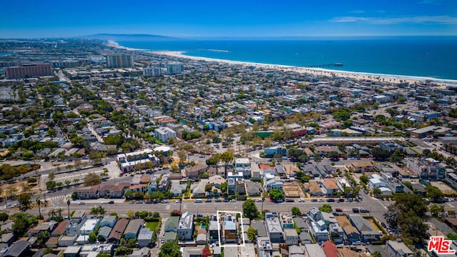 birds eye view of property with a beach view and a water view