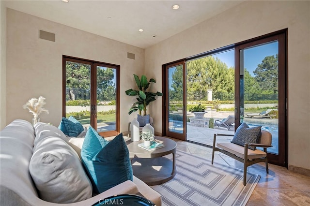 living room with plenty of natural light and french doors