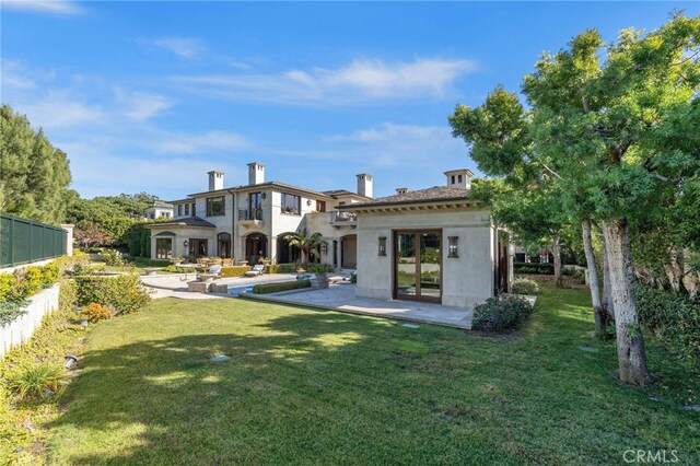 7 Shoreview, Newport Coast, CA 92657 - back of house with a lawn, stucco siding, and a patio area