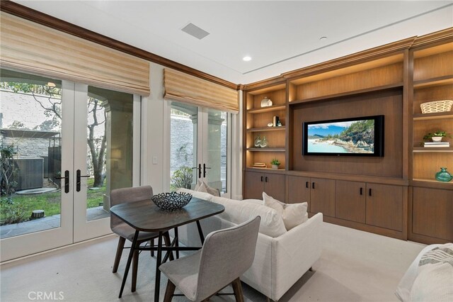 interior space featuring built in features, a wealth of natural light, and french doors