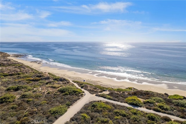 bird's eye view featuring a view of the beach and a water view