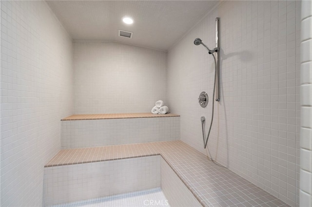 bathroom with a tile shower