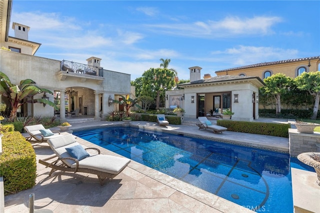 view of swimming pool with a patio area