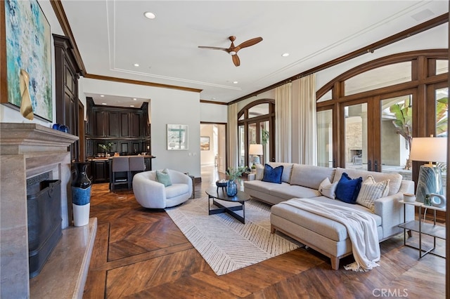 living room featuring dark parquet flooring, a wealth of natural light, crown molding, and ceiling fan