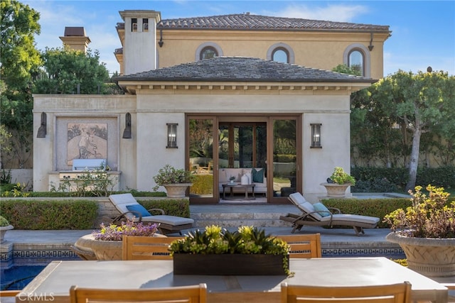 7 Shoreview, Newport Coast, CA 92657 - rear view of property with an outdoor living space with a fire pit, stucco siding, and a patio area