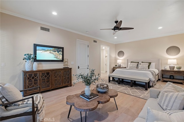 bedroom with ceiling fan, ornamental molding, and light wood-type flooring