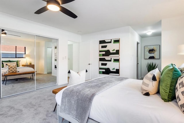 carpeted bedroom with ceiling fan and a closet