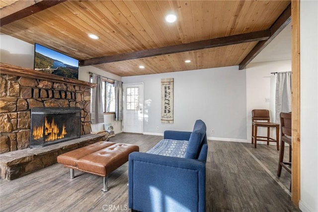 living room featuring wood-type flooring, a stone fireplace, wood ceiling, and beam ceiling