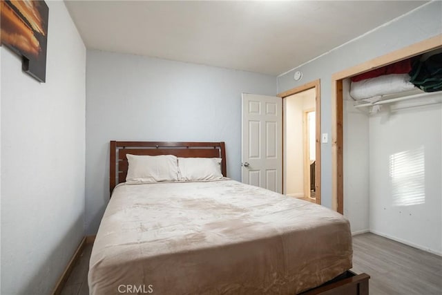 bedroom with hardwood / wood-style flooring and a closet