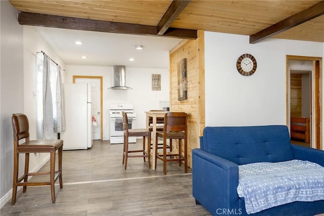 living area featuring hardwood / wood-style floors, beam ceiling, wood walls, and wood ceiling