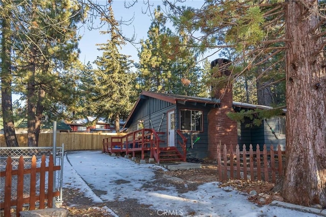 view of snow covered exterior with a deck