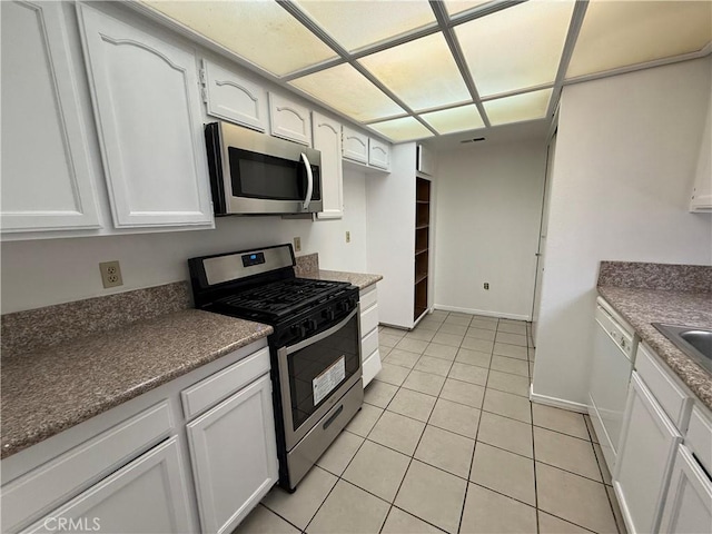 kitchen featuring white cabinets, light tile patterned floors, stainless steel appliances, and sink