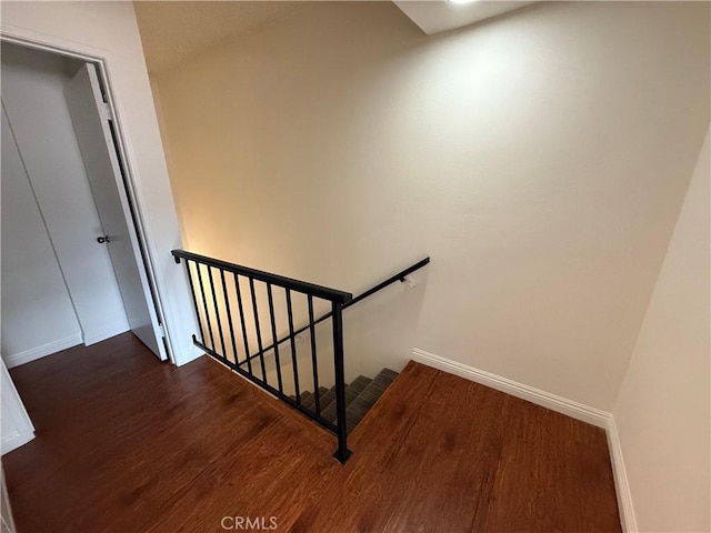 stairs featuring hardwood / wood-style floors