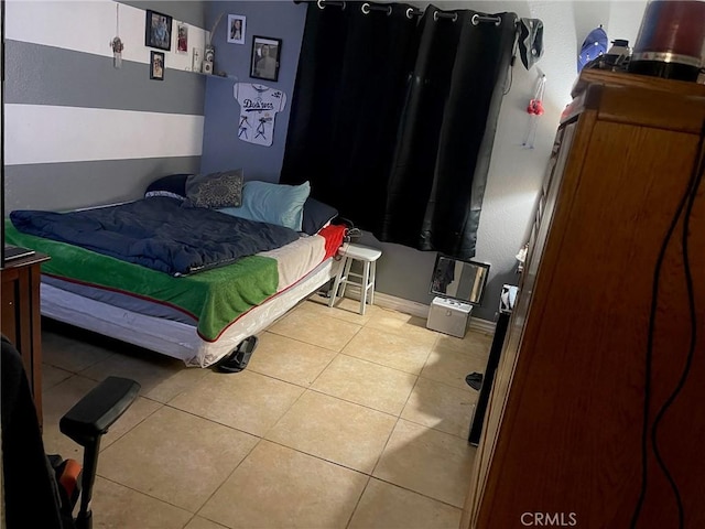 bedroom featuring light tile patterned flooring