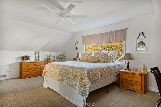 bedroom with baseboards, vaulted ceiling, a ceiling fan, and light colored carpet