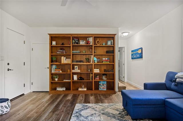 living area with wood finished floors and baseboards