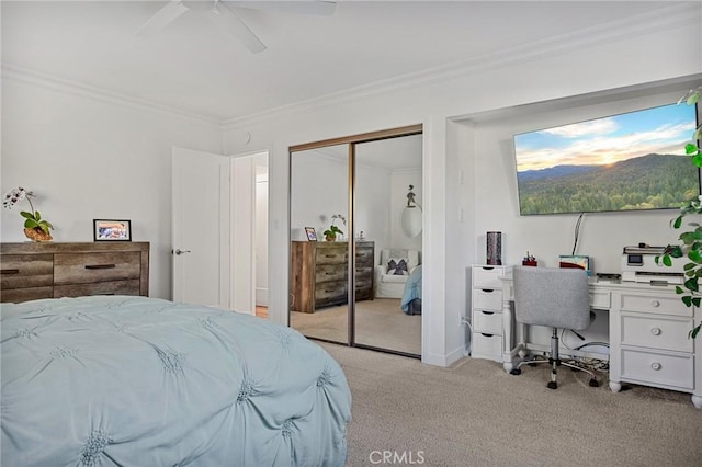 bedroom featuring light carpet, ceiling fan, ornamental molding, and a closet