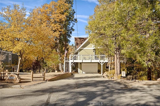 view of front facade with a wooden deck and stairs