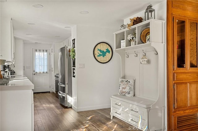 mudroom featuring dark wood-style floors and baseboards