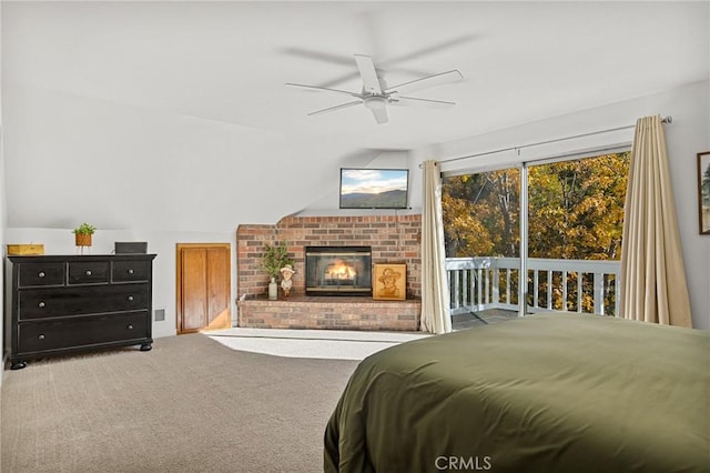 bedroom with ceiling fan, access to outside, carpet floors, and a fireplace