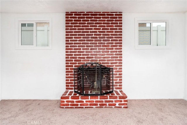 room details with carpet flooring and a fireplace