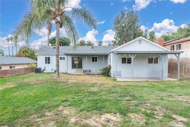 rear view of house with a patio area, a yard, and cooling unit