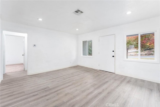 spare room with light wood-type flooring