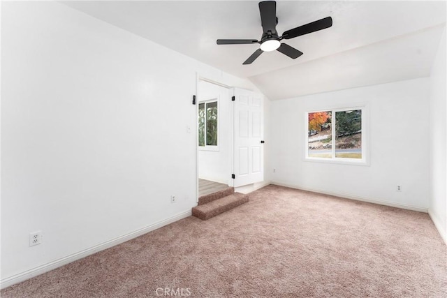 empty room with light carpet, ceiling fan, and lofted ceiling