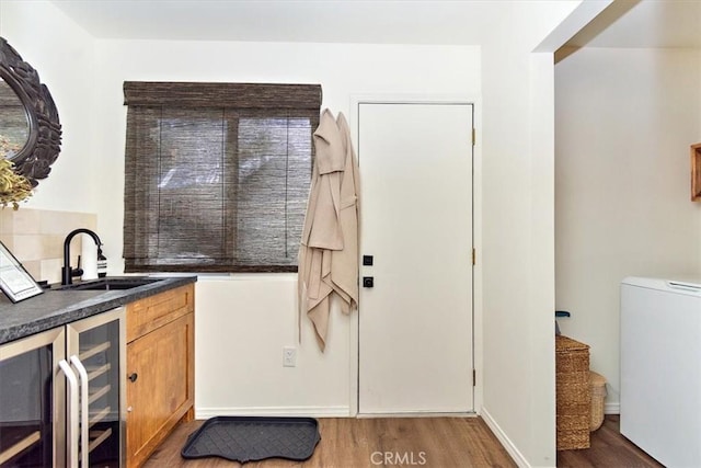 kitchen with dark hardwood / wood-style floors, wine cooler, and sink