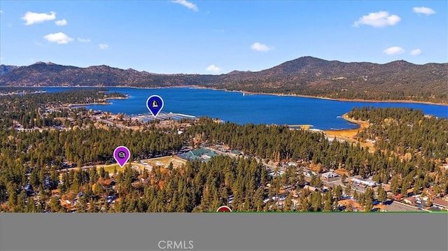 birds eye view of property with a water and mountain view