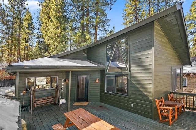 back of house with a deck