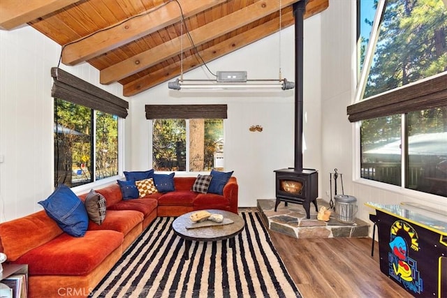 living room featuring a wood stove, high vaulted ceiling, hardwood / wood-style flooring, beamed ceiling, and wood ceiling