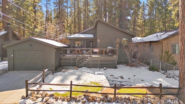 exterior space featuring a deck, a garage, and an outdoor structure