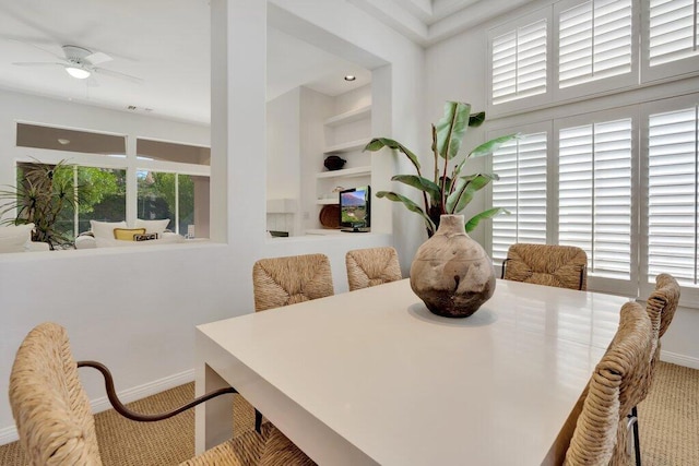 dining area with ceiling fan and carpet flooring