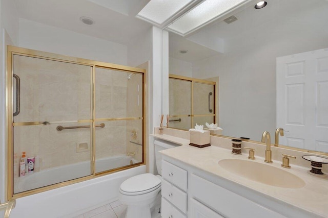 full bathroom with combined bath / shower with glass door, vanity, toilet, and tile patterned flooring