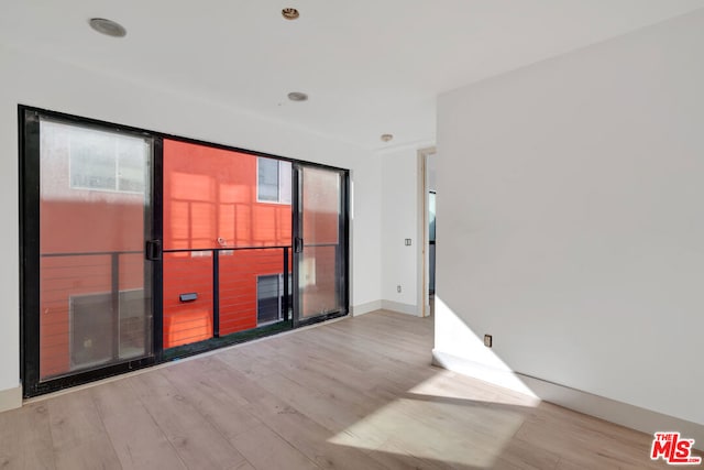 unfurnished room with light wood-type flooring