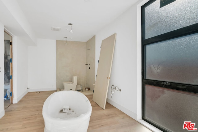 bathroom featuring hardwood / wood-style floors and toilet