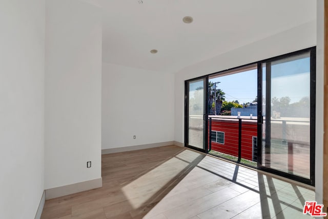 unfurnished room featuring light hardwood / wood-style floors