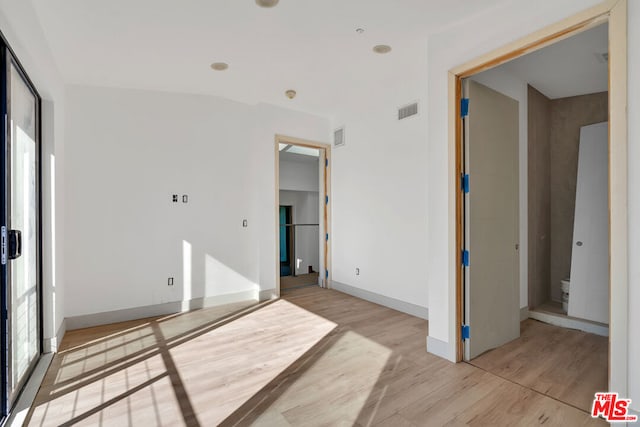 unfurnished room featuring light wood-type flooring