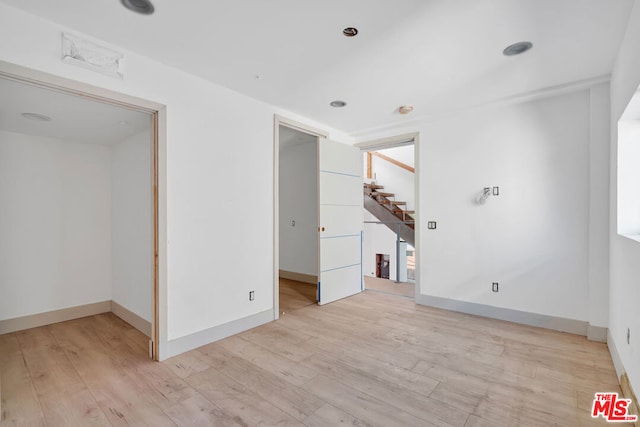 empty room with light hardwood / wood-style flooring